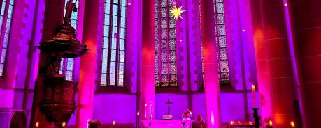 Foto des Altarraumes der Heiliggeistkirche ganz in pink beleuchtet